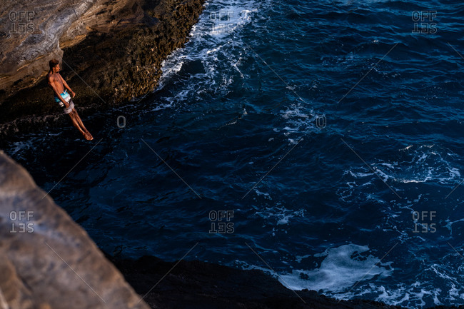 Honolulu, hi, united states - january 23, 2019: male cliff diver in action at the ocean cliffs of oahu, hawaii