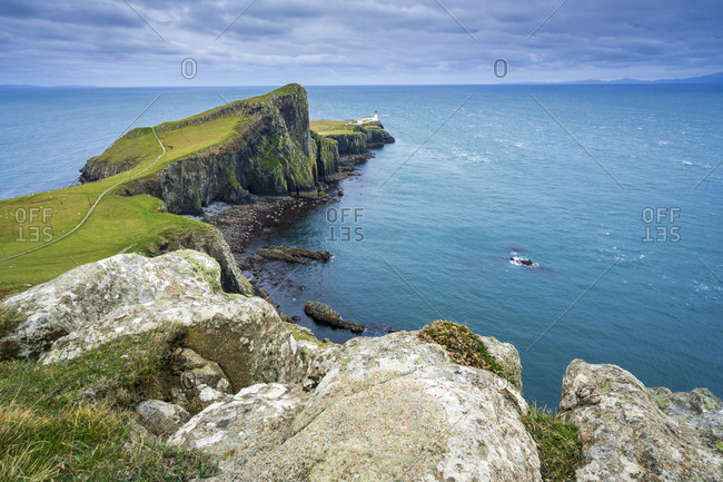 Distant view of neist point lighthouse, isle of skye, scotland, uk