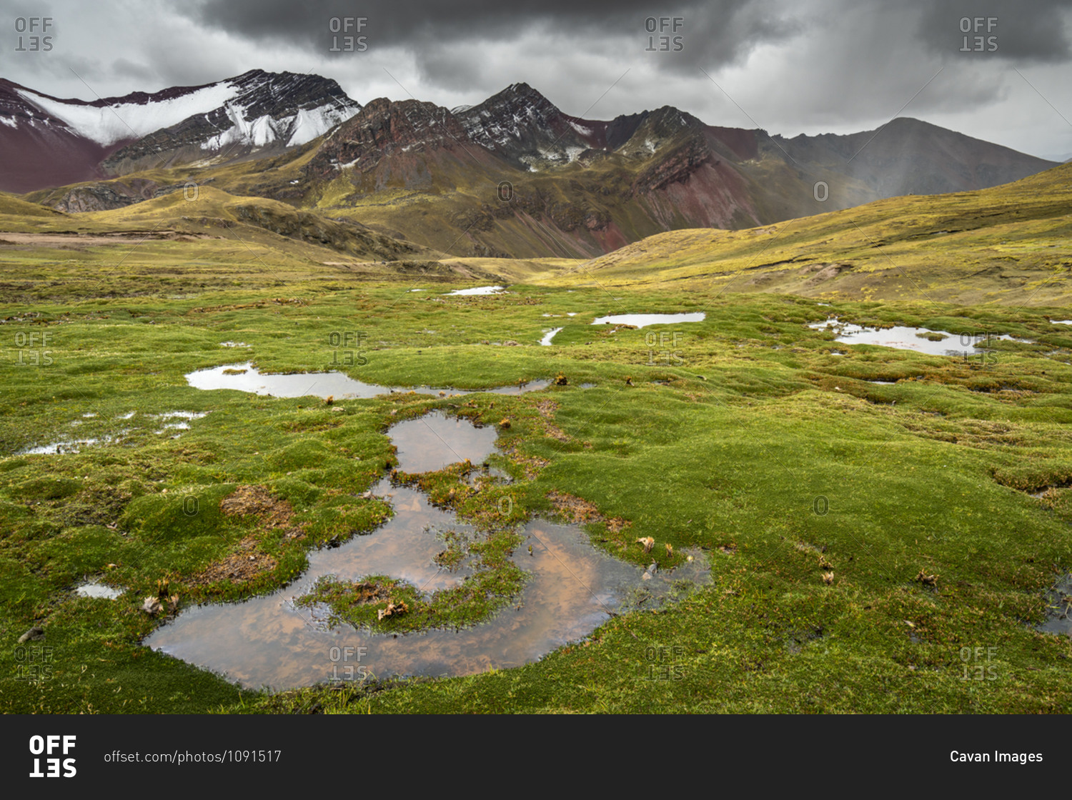 Puddles on meadow at rainbow mountain trail, pitumarca, peru