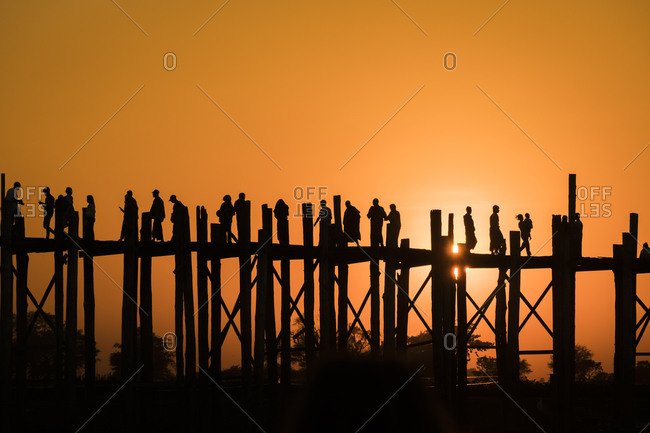 Silhouette people walking on u bein bridge against clear sky during sunset, amarapura, mandalay, myanmar