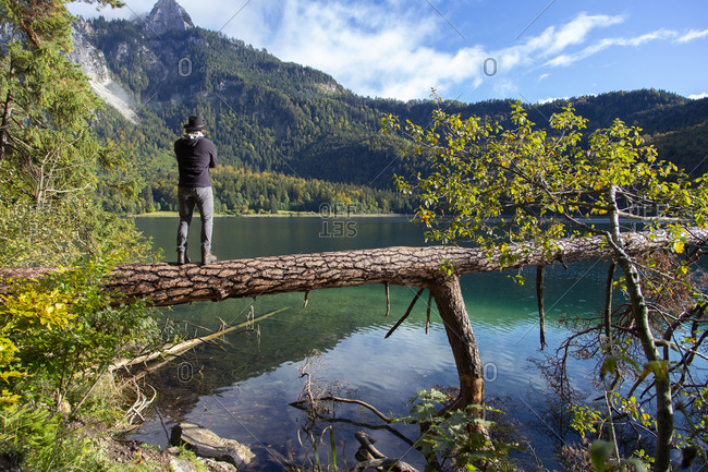 A person looking across a clear alpine lake on a sunny day in germany