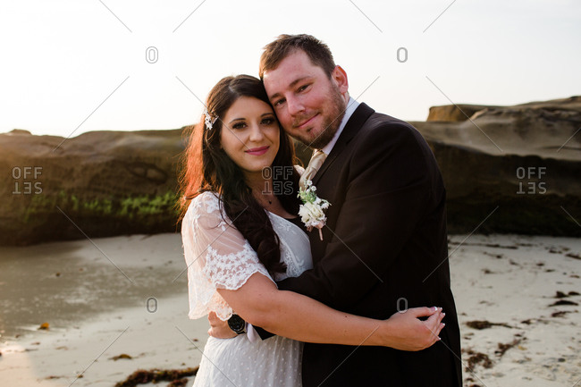 Newlyweds on beach at sunset in san diego