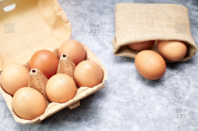 Chicken eggs in their carton and raffia bag. healthy food concept