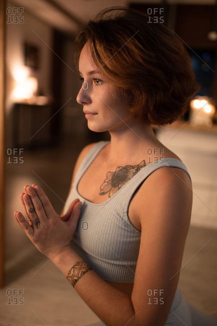 Young female doing yoga with namaste hands
