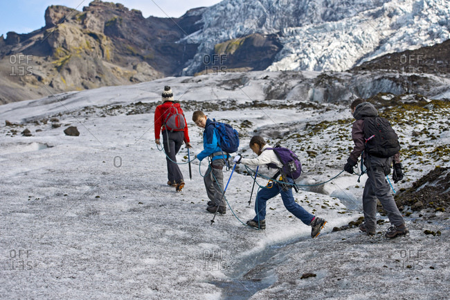 Family exploring the edges of vatnajokull glacier in iceland