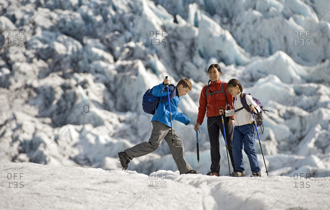 Family exploring the edges of vatnajokull glacier in iceland