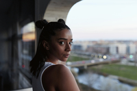 Young woman with her hands on her bare stomach stock photo - OFFSET