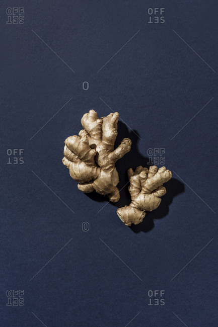 Overhead view of ginger root on blue surface