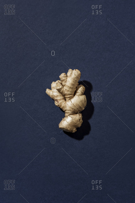 Top view of ginger root on blue surface
