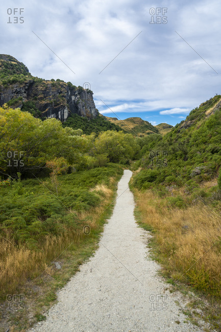 Trail amidst grassy field at diamond lake conservation area, new zealand
