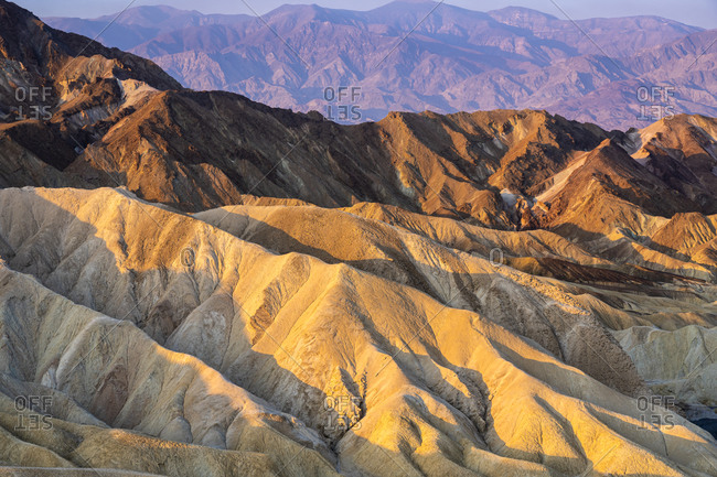 Scenic view of natural rock formations at zabriskie point after sunrise, death valley national park, california, usa