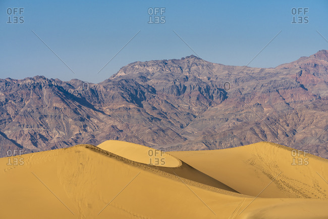 Scenic view of mesquite flat sand dunes and rocky mountains in desert, death valley national park, california, usa