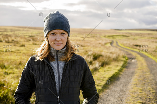 Red headed woman going for a walk in the english countryside