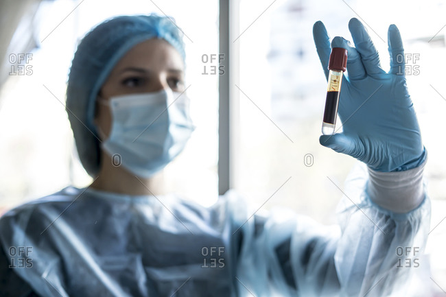 Medical doctor or laborant holding tube with ncov coronavirus vaccine for 2019-ncov virus.