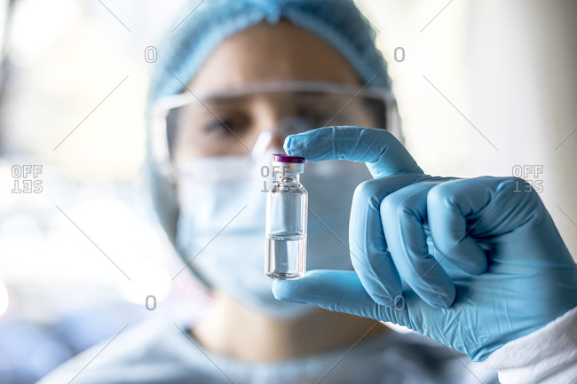Medical doctor or laborant holding tube with ncov coronavirus vaccine for 2019-ncov virus.