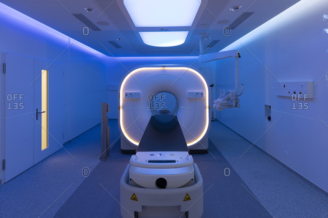 View of a scanner room bathed in blue light