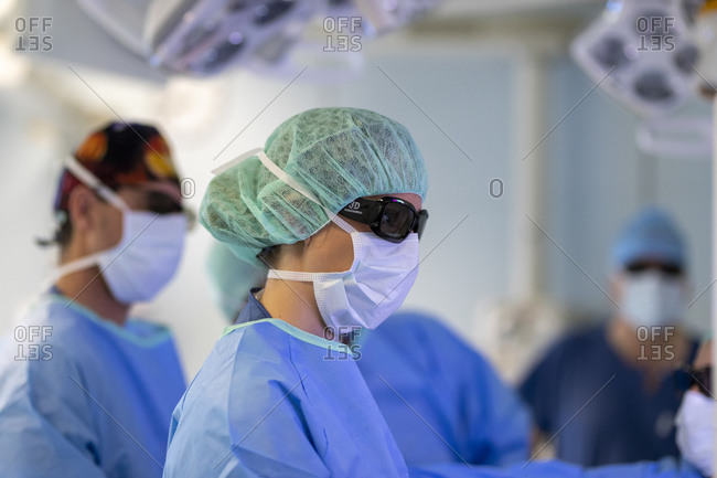 Three surgeons are in the operating room during surgery