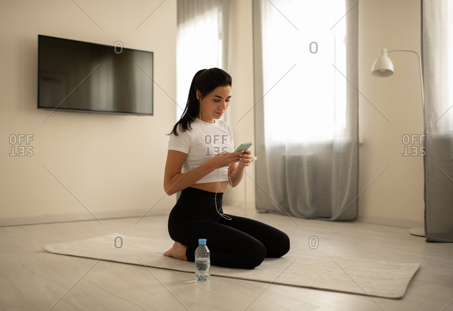 Sporty female using smartphone during workout