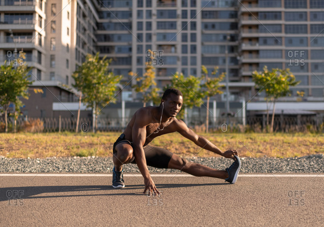 Naked torso black man warming up body before training