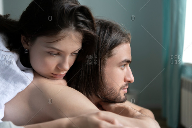 Portrait of husband and wife lying on the pillow at their bedroom