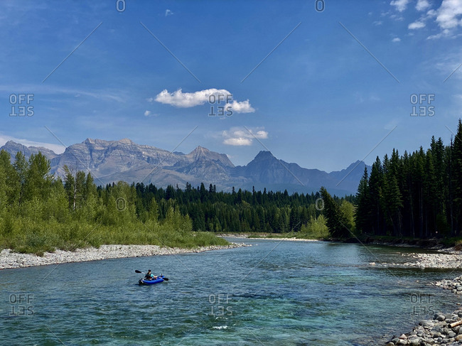 A young woman floats on a north fork of the flathead river.