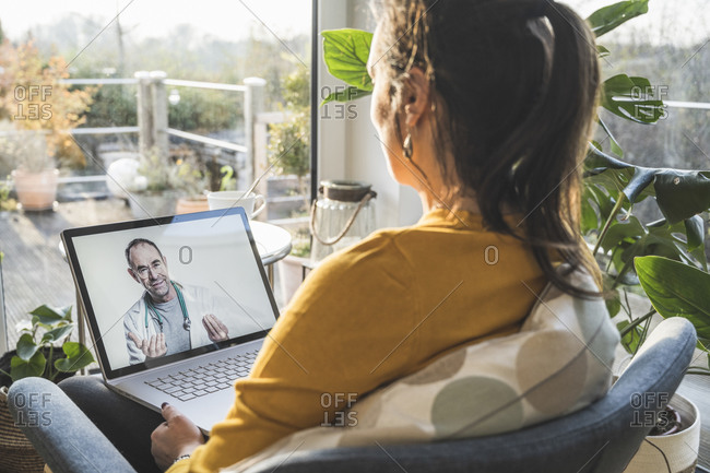 Woman consulting with doctor during video call on laptop