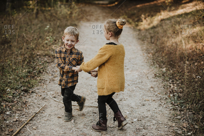A Boy And Girl Holding Hands Stock Photos Offset