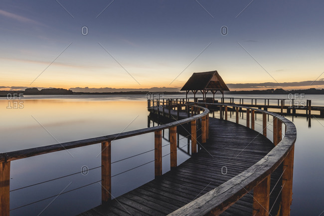 Germany- Schleswig-Holstein- Hemmelsdorf- Empty pier on shore of Hemmelsdorfer See lake at dawn
