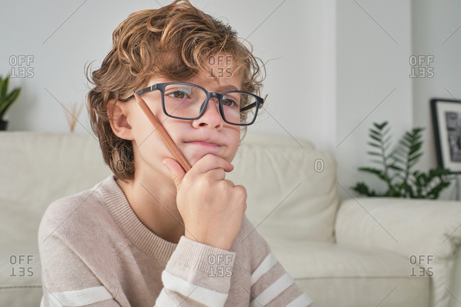 Young boy thinking ideas to create content for his channel.