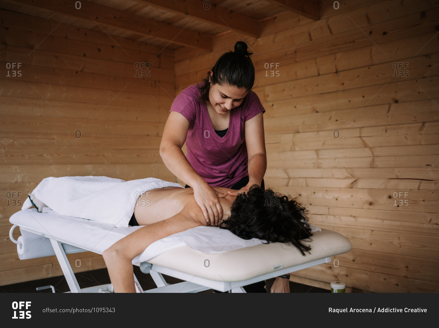 Crop unrecognizable female therapist applying lotion and preparing for doing massage for client in spa salon