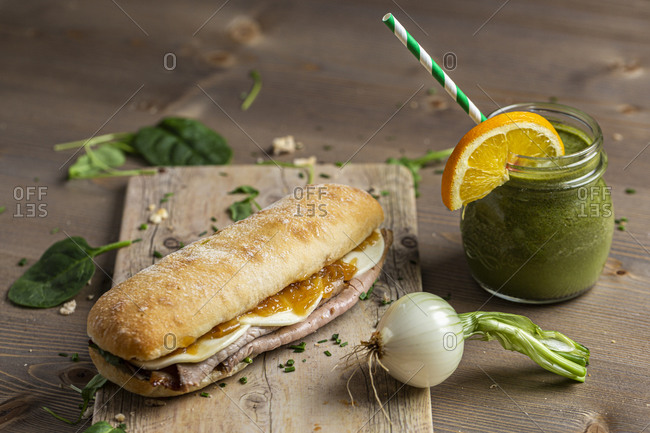 Healthy sandwich of roast beef with vegan smoothie