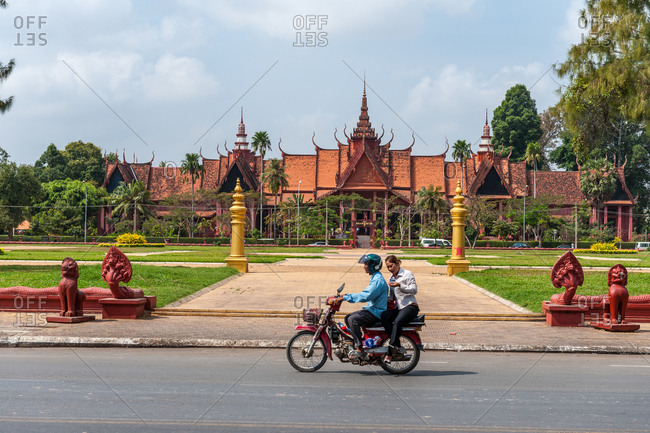 National Museum, Phnom Penh, Cambodia - 07 February 2009: Motorbike Taxi Takes Customer Past One Of Phnom Penh'S Most Iconic Buildings, The National Museum.