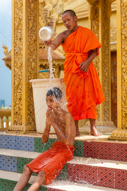 Wat Khleang, Phnom Penh, Cambodia - 04 July 2010: Monk Performs Cleansing Ceremony On Lay People Who Want To Be Blessed.