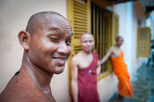 Wat Ounalom, Phnom Penh, Cambodia - 30 July 2011: Monk With Hair Trimmings On Shoulder Just After Having His Head Shaved By Fellow Monks.
