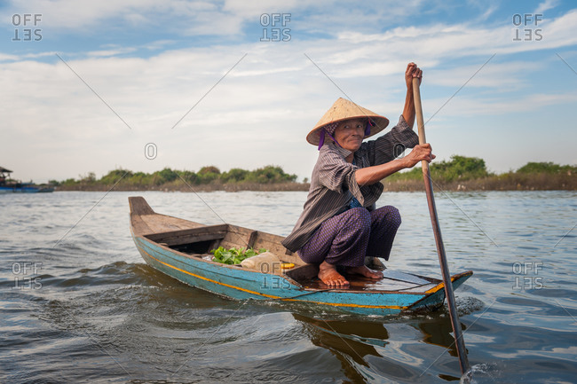 Kompong Luong Floating Village, Krakor District, Cambodia - 10 January 2012: Old Khmer Lady Rows Home To Cambodian Floating Village.