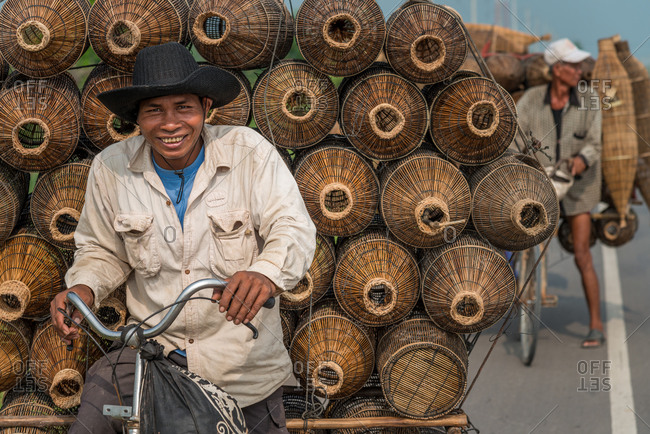 Mobile Salesman, Cambodia - 14 April 2012: Khmer Man Sells Fishing Baskets From Bicycle.