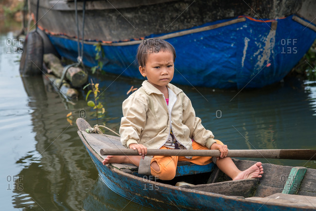 Kompong Luong Floating Village, Krakor District, Cambodia - 15 April 2012: Young Khmer Girl Rows Through Cambodian Floating Village.