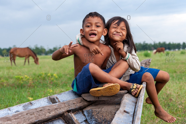 Portrait, Portrait, Kompong Cham Province, Cambodia - 20 August 2012: Friends Play On A Boat Left High And Dry In A Field During The Dry Season.