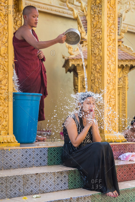 Wat Khleang, Phnom Penh, Cambodia - 06 February 2014: Monk Performs Cleansing Ceremony On Lay People Who Want To Be Blessed.