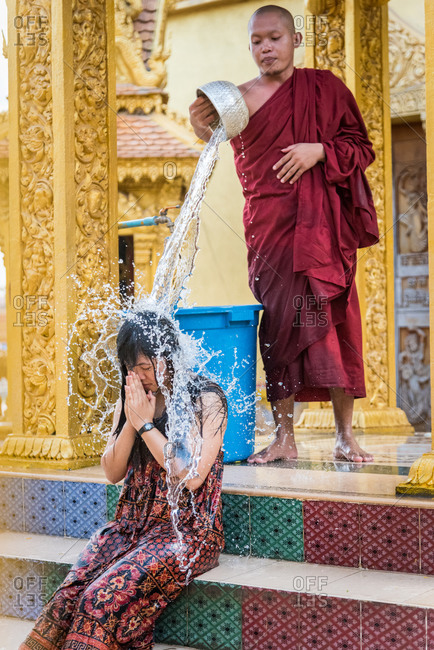Wat Khleang, Phnom Penh, Cambodia - 06 February 2014: Monk Performs Cleansing Ceremony On Lay People Who Want To Be Blessed.