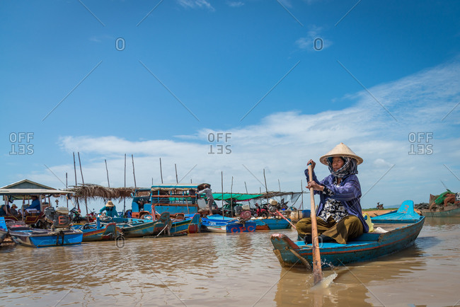 Kompong Luong Floating Village, Krakor District, Cambodia - 24 June 2014: Elder Khmer Women Rows Through Cambodian Floating Village.