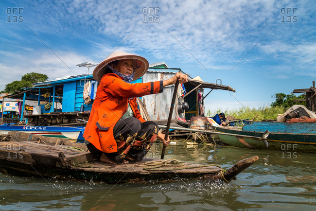 Kompong Luong Floating Village, Krakor District, Cambodia - 29 July 2014: Khmer Women Rows Through Cambodian Floating Village.