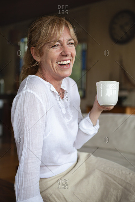Smiling senior woman having coffee