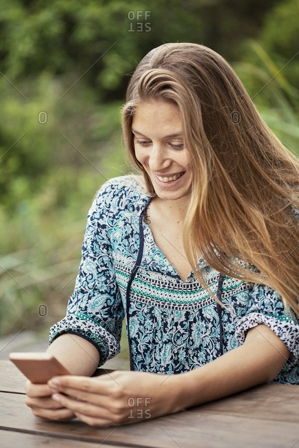 Smiling mid adult woman using smartphone
