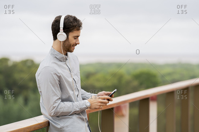 Young man listening music on smartphone