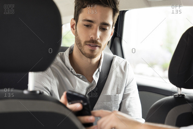 Taxi driver's hand pointing touch screen