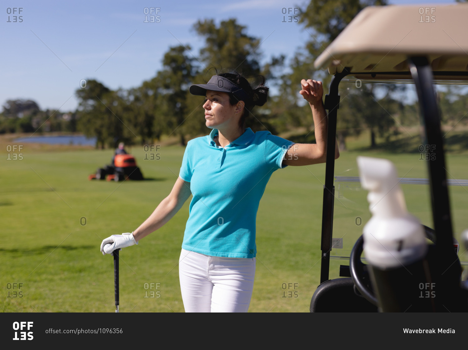 Caucasian woman playing golf leaning on golf cart at golf course. sport leisure hobbies golf healthy outdoor lifestyle.