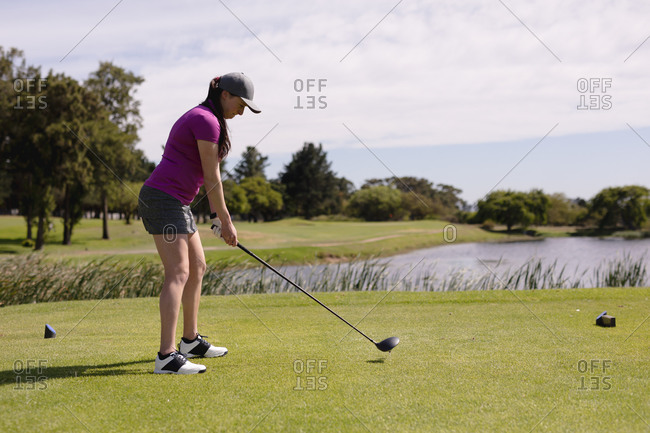 Caucasian woman playing golf swinging club and taking a shot. sport leisure hobbies golf healthy outdoor lifestyle.