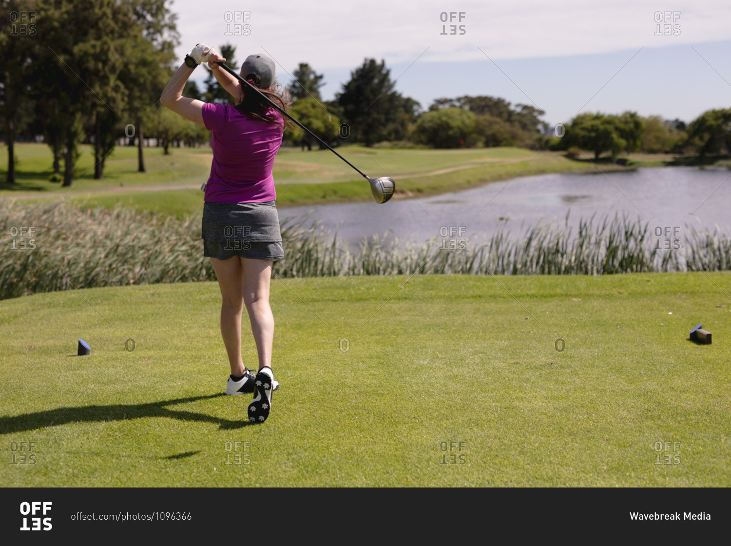 Caucasian woman playing golf swinging club and taking a shot. sport leisure hobbies golf healthy outdoor lifestyle.