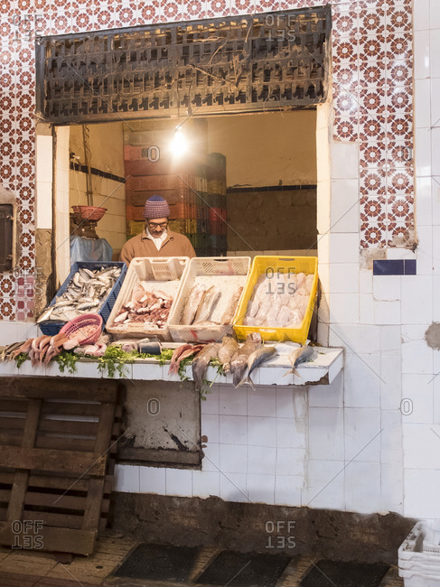 Marrakesh, MOROCCO - January 2017: Unknown man selling fish in traditional shop in Fez, Morocco